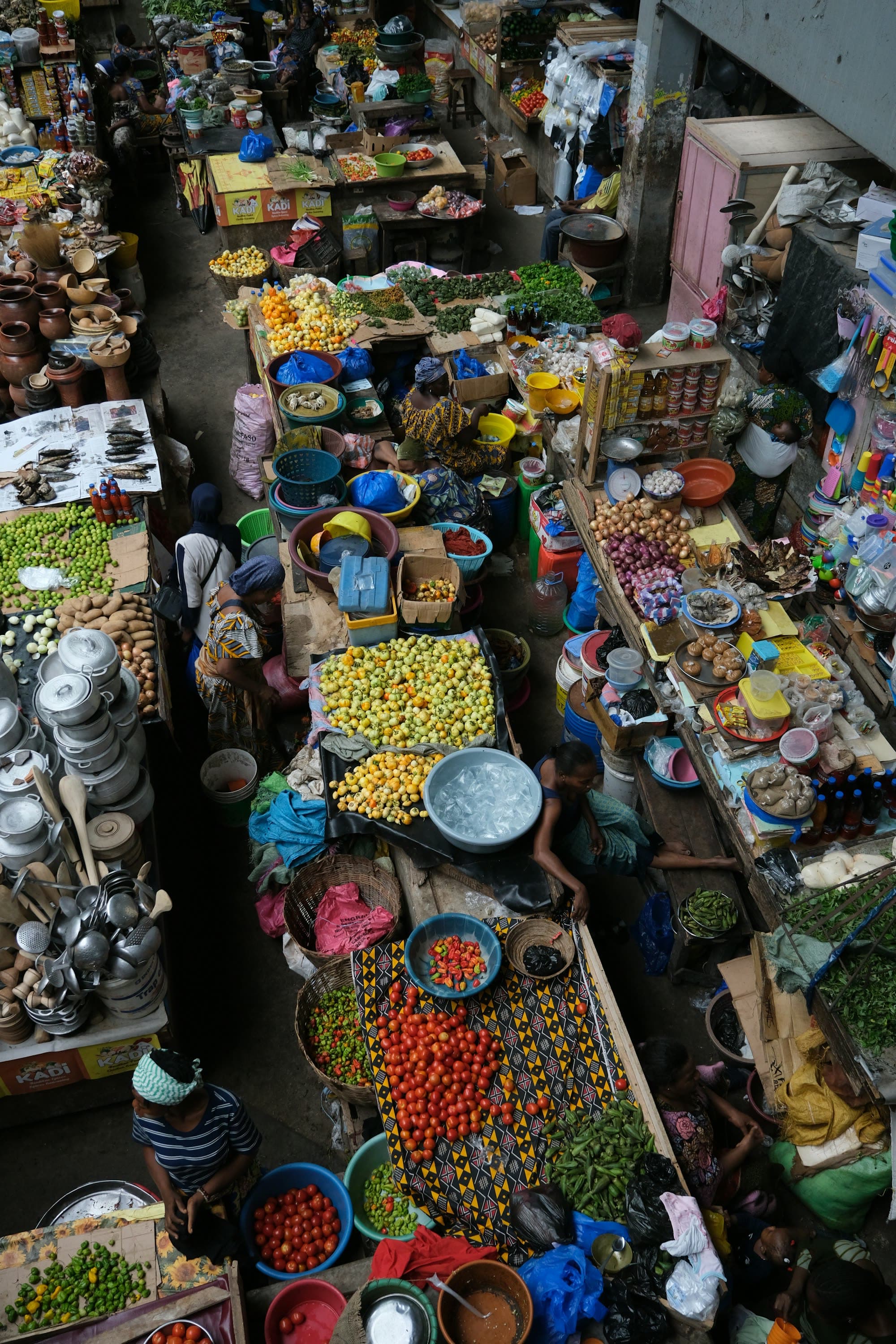 Vue plongeante sur un marché, ses bassines d'épices, de graines et de légumes